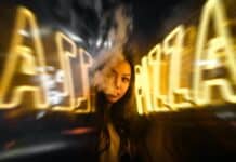 woman near yellow neon sign