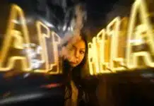 woman near yellow neon sign