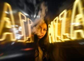 woman near yellow neon sign