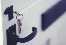 black and silver padlock on white door