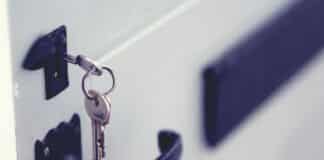 black and silver padlock on white door