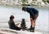 boy and man beside river during daytime